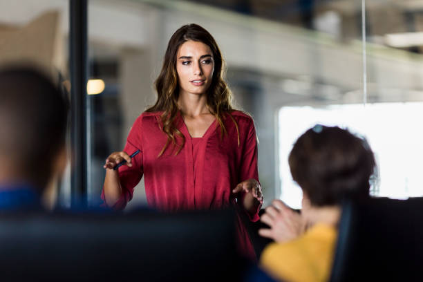 Confident woman sharing ideas with colleagues