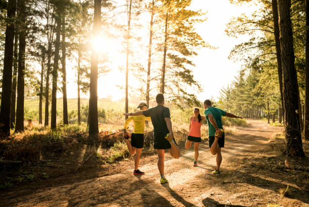 istock Friends stretching legs before jogging on road 642479128