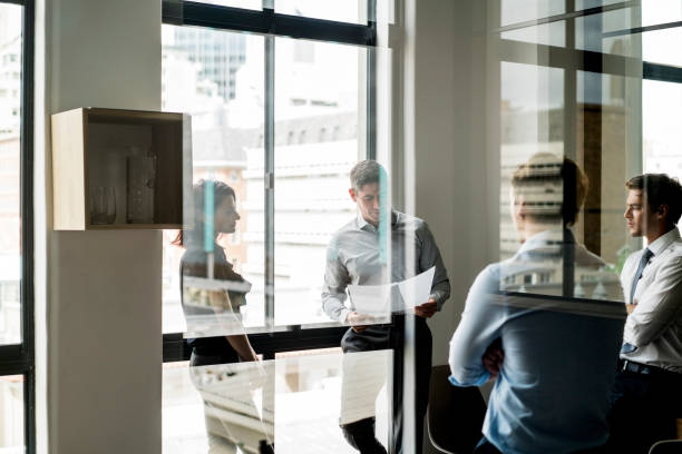 istock Business people discussing in board room meeting 642479630