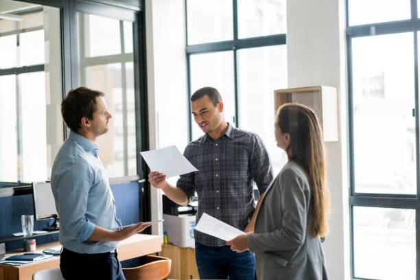 istock Businessman with tablet looking at colleagues 642479634