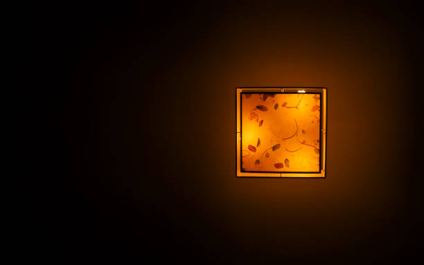 Bottom view of hanging plastic square ceiling lamp with a yellow dim light