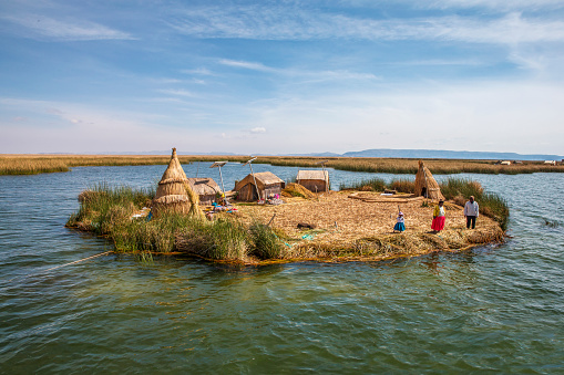 Puno, Peru - November 17, 2016 : Floating islands of late Titicaca of Puno Peru. Local tribes living on floating islands made out of reeds on the worlds highest navigable lake, Titica. There are usually 2-8 families live on these small islands. These days their main income is from tourism.