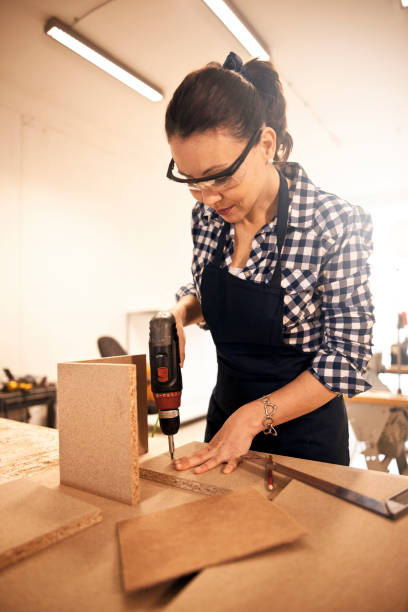 istock Female carpenter screwing 642509494