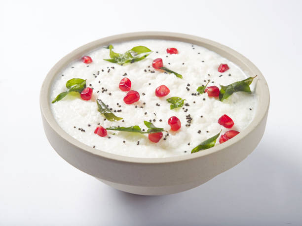 curd rice garnished with pomegranate curd rice garnished with pomegranate served in a white bowl on white background curd cheese stock pictures, royalty-free photos & images