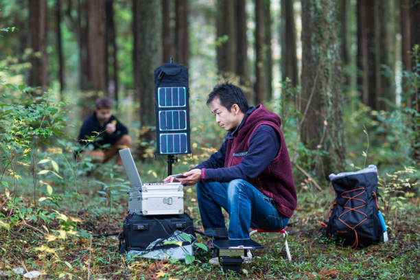 istock Two researchers work in the forest with solar powered field laboratory 642514738