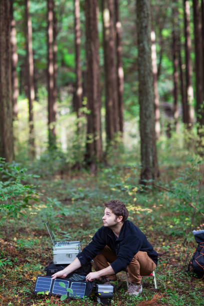 istock Scientist gathering data in forest with solar powered field station. 642515454