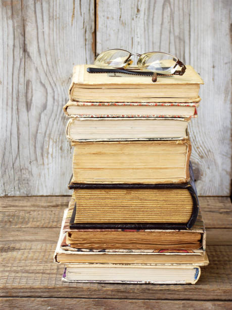 istock Stack of old hardback books on wooden background. Selective focus 642525058