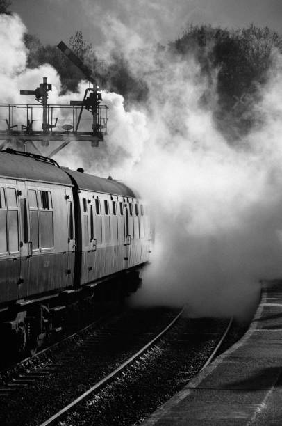 istock Steam train pulling away from station through cloud of steam 642529510