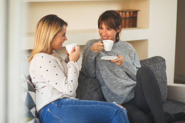istock Two young cheerful female friends enjoying coffee and conversation 642532736