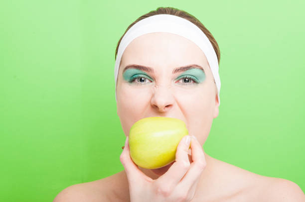 istock Beautiful female biting organic apple 642536014