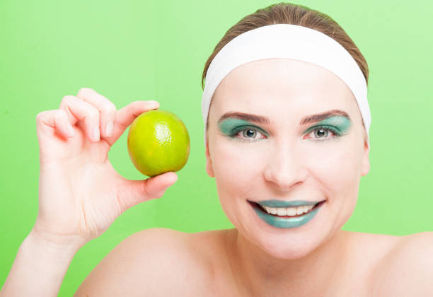 istock Beautiful female with lime in hand 642536268