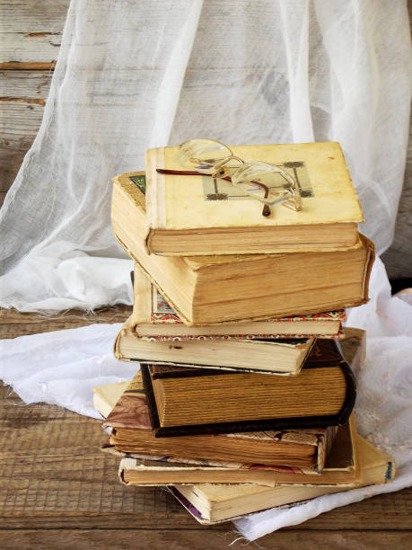 istock Stack of old hardback books on wooden background. Selective focus. Copy space 642543662