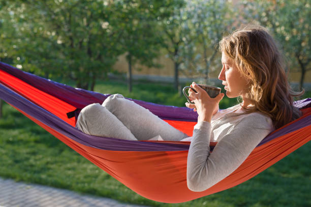 istock Young woman relaxing in hammok 642543900