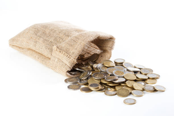 istock Coins falling out of a small burlap sack, on white isolated background. 642551334
