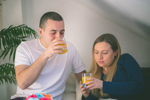 istock Happy couple relaxing together on their bed 642557334