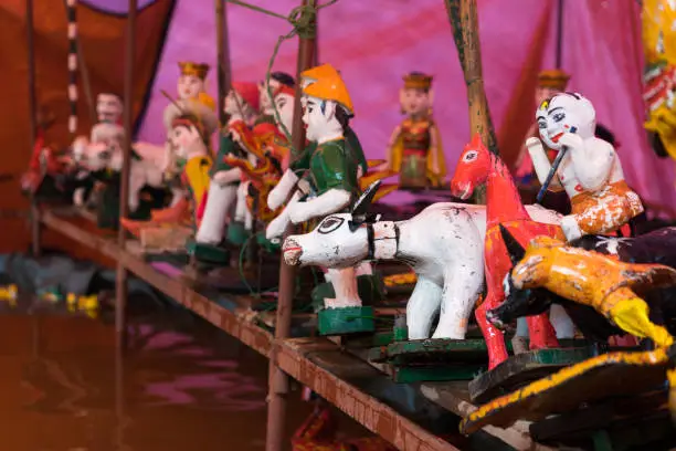 Photo of Common Vietnamese water puppets behind puppetry state. The control room is dark to hide puppeteers and instruments