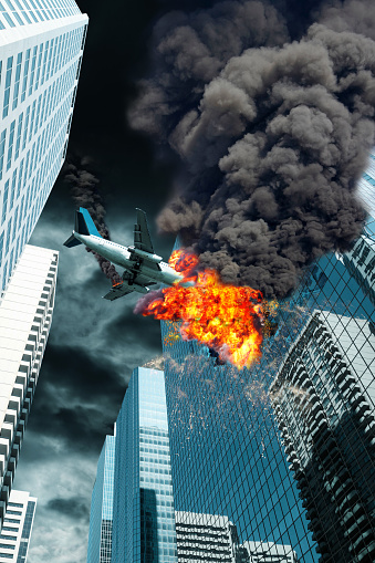 A cinematic portrayal of an airplane disaster with its engine on fire as it crashes a downtown building. Concept of accident, end times or act of terrorism.
