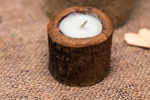 istock Candle in a wooden candlestick on a romantic background 642562878