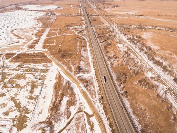 istock Snowy and frozen winter road 642563056