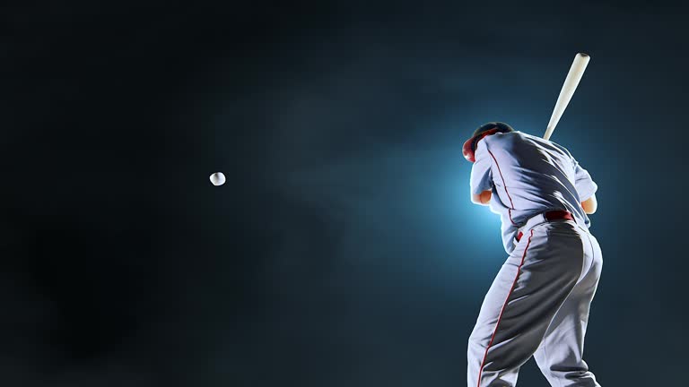 Baseball batter hitting ball during game