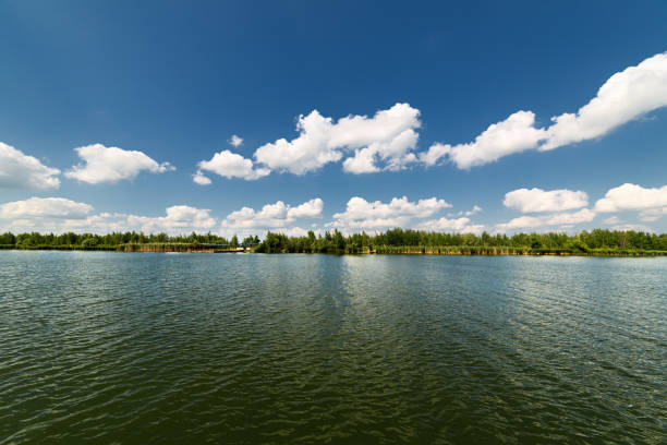 istock Clean lake and beautiful blue sky with clouds 642566334