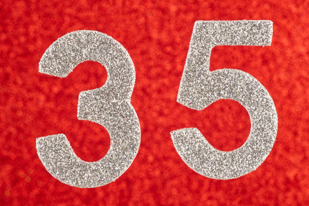 istock Number thirty-five silver color over a red background. Anniversary. 642566736