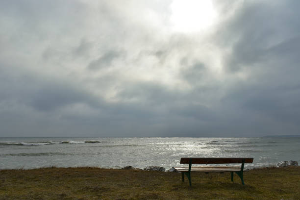istock Old bench by the sea in a dark winter day 642567542