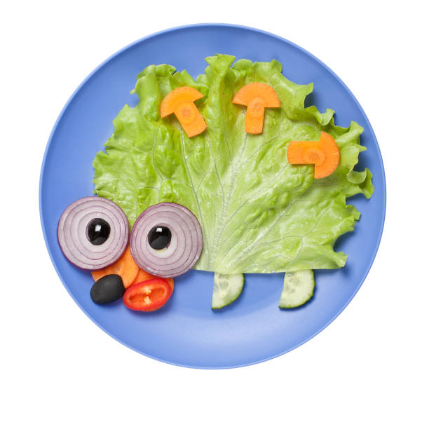 istock Amusing hedgehog made of vegetables on blue plate 642577388