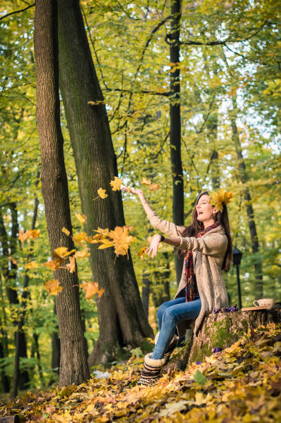 istock girl throws up leaves 642591518