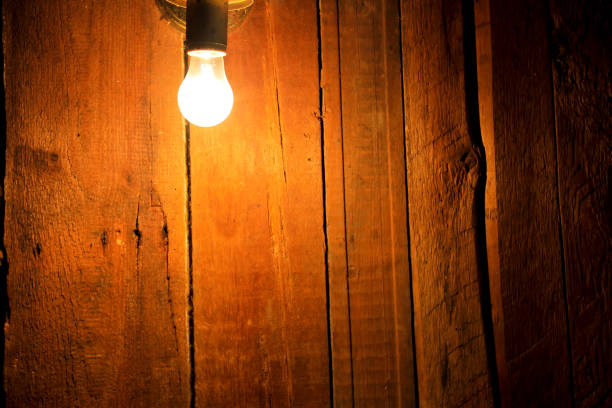 istock Electric light bulb on wooden background 642592306