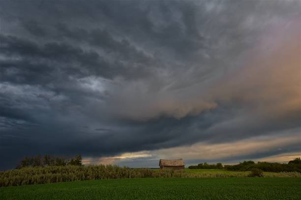 istock Sunset clouds over field and house 642595122