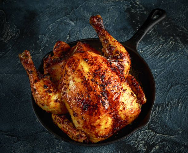 istock Organic cornfed free range oven baked chicken in rustic pan with lemon slices and rosmary 642602704