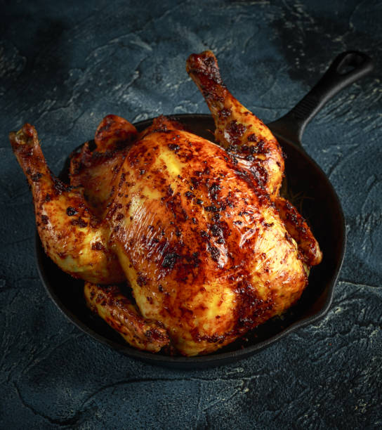 istock Organic cornfed free range oven baked chicken in rustic pan with lemon slices and rosmary 642602784