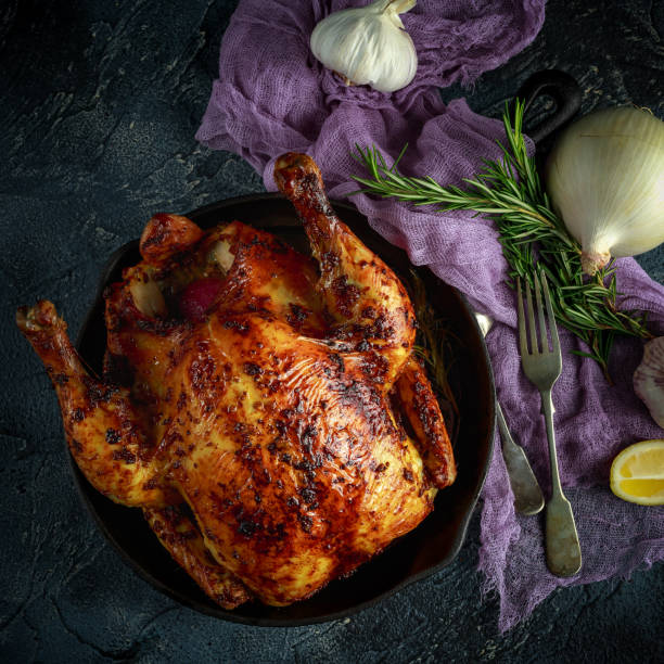 istock Organic cornfed free range oven baked chicken in rustic pan with lemon slices and rosmary 642603414