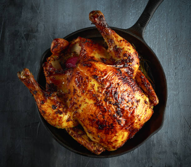 istock Organic cornfed free range oven baked chicken in rustic pan with lemon slices and rosmary 642603574