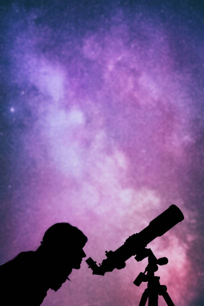istock Girl looking at the stars through a telescope. 642609538
