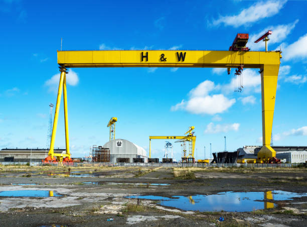 Big blue panoramic skies over the cargo cranes, shipyards and working docks reflecting in the tranquil waters of Helsinki harbour in the heart of Finland's vibrant capital city.