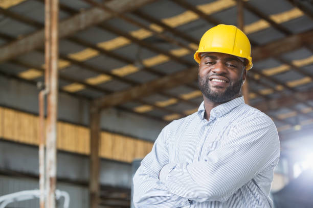 istock African American man in warehouse wearing hardhat 642609948