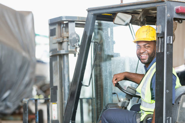 istock African American man driving forklift 642610120