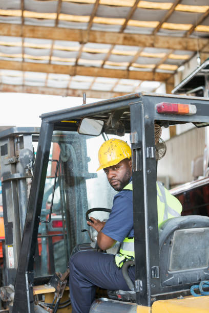 istock African American man driving forklift 642612694