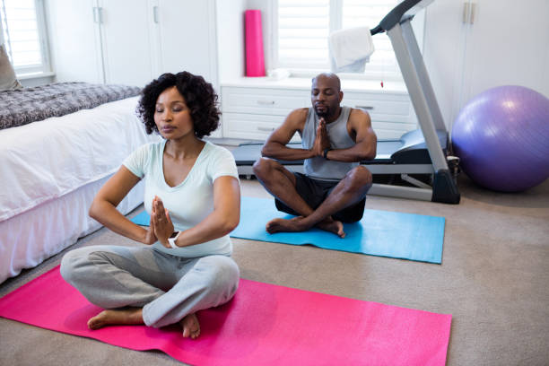 istock Couple meditating at home 642616478