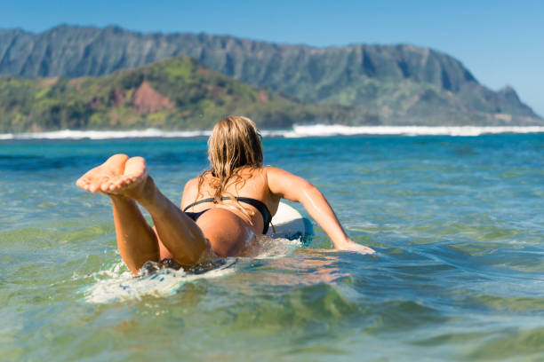 A beautiful young women surfer ready to surf