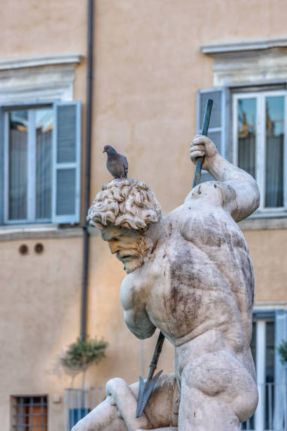 istock Sculpture of a man with spear with a pigeon on the head 642625744