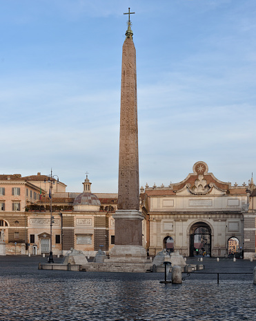 Early morning in Piazza del Popolo of Rome, view of the egyptian obelisk and of the Porta Flaminia.