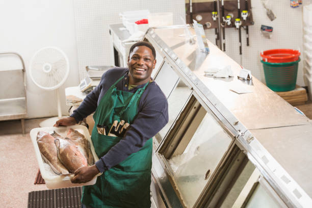 istock Black man working in fish market 642628318