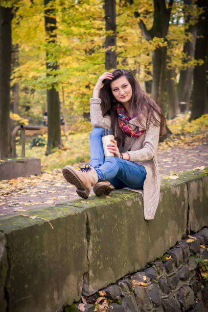 istock girl sitting on the stone 642634160