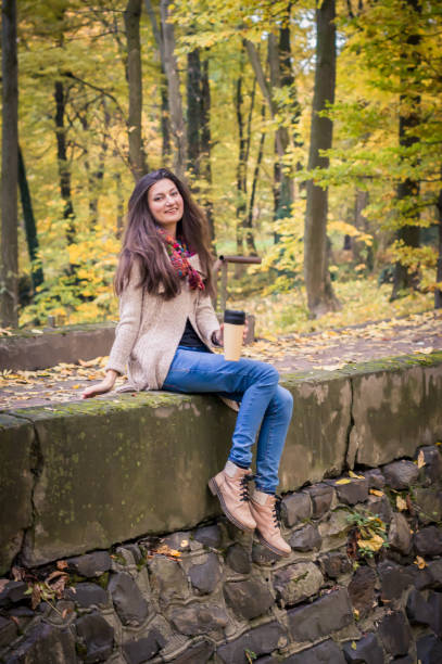 istock girl sitting on the stone 642634254