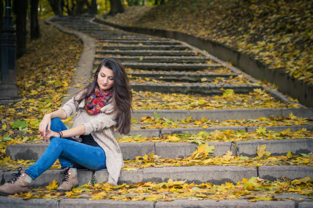 istock girl sitting on stone steps 642634956