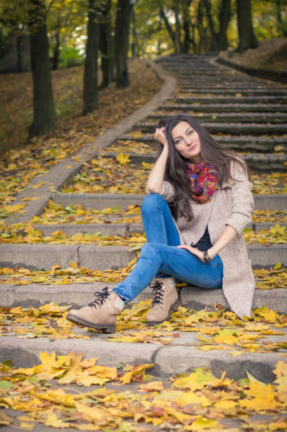 istock girl sitting on stone steps 642635106