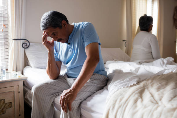 istock Tensed senior man sitting on bed 642643582